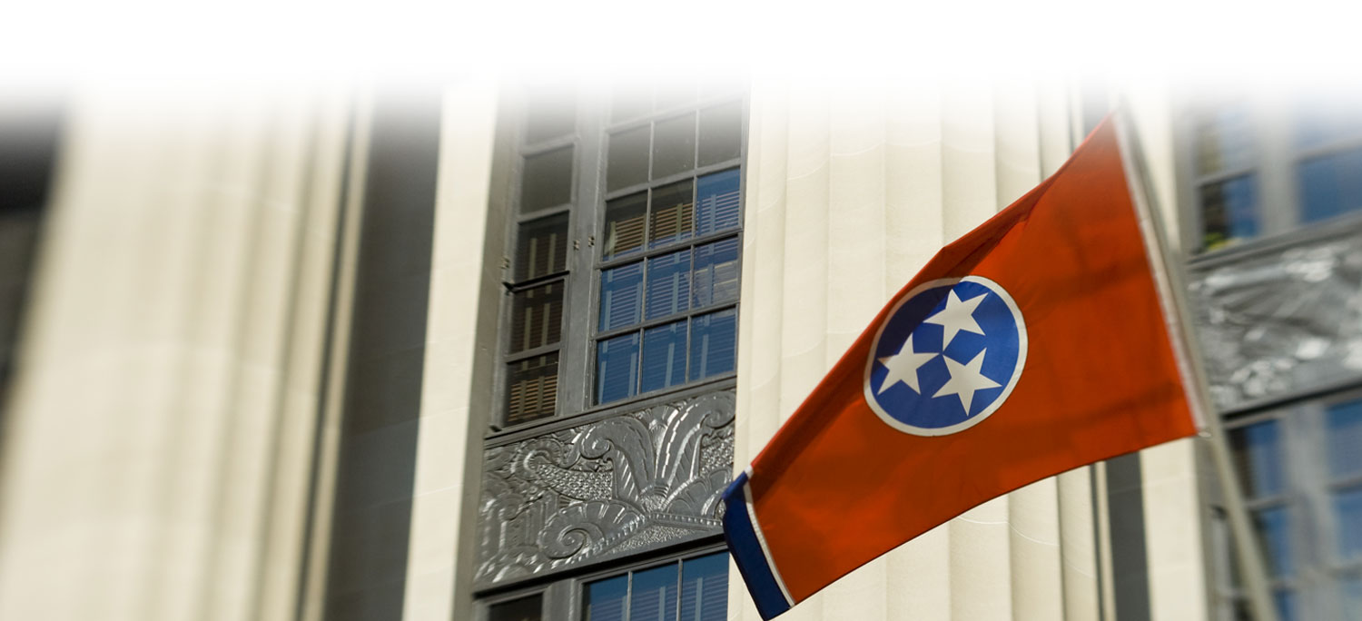 The Tennessee state flag flying outside a courthouse.